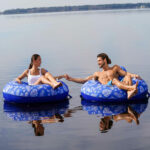 Man and Woman on Supreme Lake Tube in Hibiscus Pineapple/Royal Blue