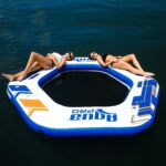 Couples using 10' Hex Dock Inflatable Island in blue, gold, and white